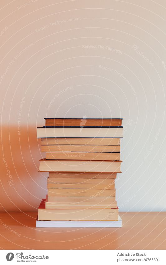 Pile of books on a piece of furniture education stack library literature pile learning read paper educational group information knowledge page study textbook