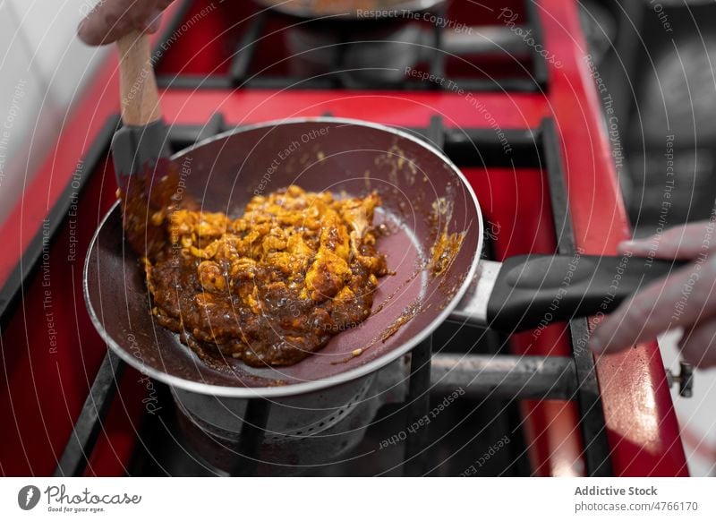 Faceless cook frying eggs with sauce Mexican food mole xiqueño mole xiqueno dish culinary cuisine mexican frying pan fried kitchen delicious tasty yummy stove