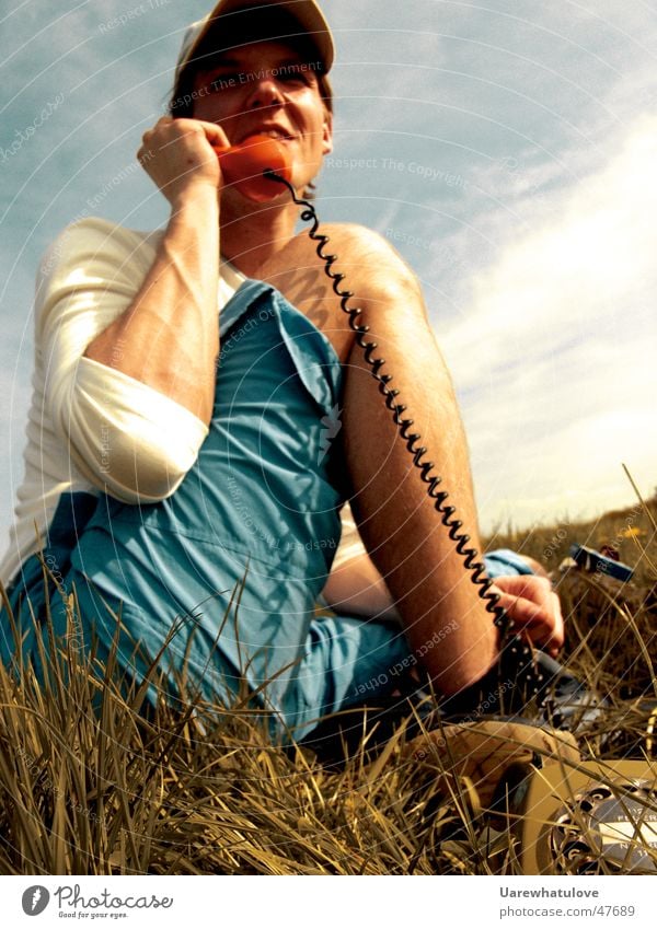 Telephoning in nature Telephone Analog Meadow Summer Portrait photograph String Human being Laughter Audience Listening capy grass Sit