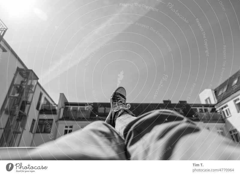 Legs up in the backyard Chucks Sky relax Prenzlauer Berg Berlin bnw b/w Interior courtyard Capital city Downtown Town Black & white photo Day Exterior shot