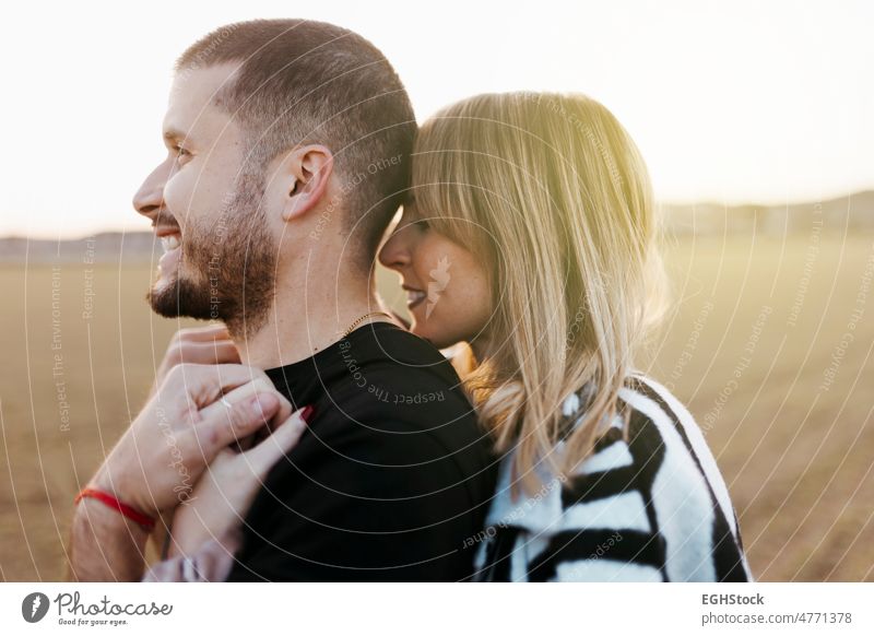 Close up couple hugging and looking at camera in the countryside embraced. Boyfriend and girlfriend in love close up two people embracing journey weekend man