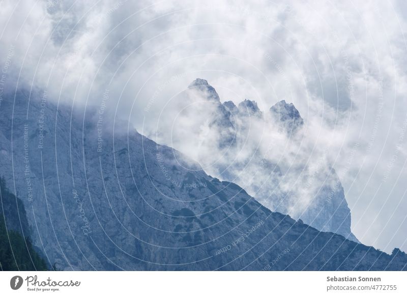 Clouds in front of a mountain peak in the Julian Alps, Triglav National Park, Slovenia Rock Nature Mountain Sky Landscape panorama Blue Tourism Hiking travel