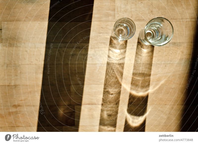 Shadow of the glasses on the garden table Table Bird's-eye view Glass drinking glass Beverage Drinking Thirst Wood Wooden table Wood grain Light Refraction