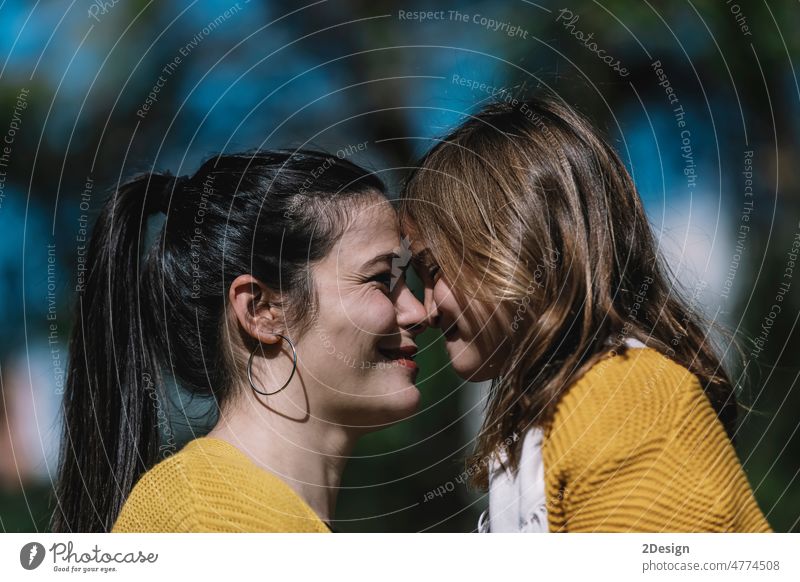 Little cute child baby girl kiss on cheek and hug, embrace with happy pretty woman in green park. parent together daughter happiness joy love mom mother