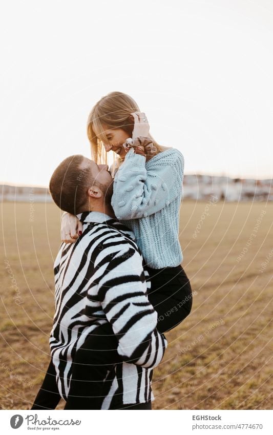 Boyfriend pick up his girlfriend. Couple in love in the countryside embraced. boyfriend close up two people couple embracing man woman adult nature outdoors