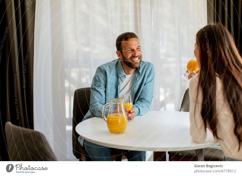 Young couple in the living room adult boyfriend carefree lifestyle caucasian communication couch female happiness happy home house husband indoors leisure love