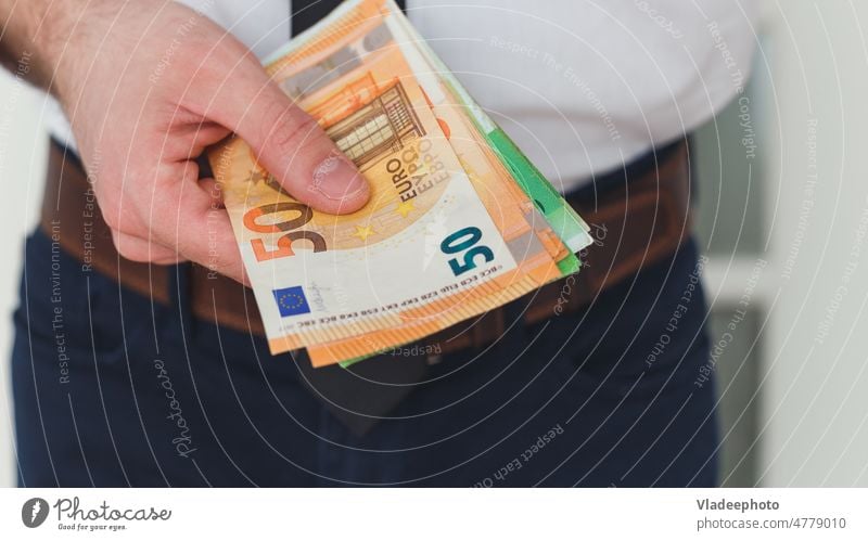 Detail of man hands with money, euro notes business currency cash finance banking trade salary income financial wealth european investment rich economy pay loan