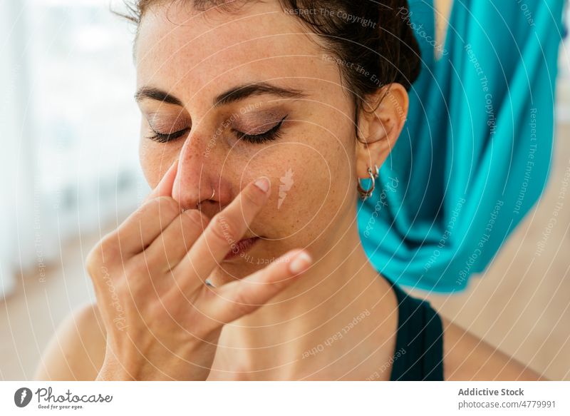 Woman doing breathing exercise during yoga session woman swing breathe training practice studio hammock healthy lifestyle class spacious wellness activity