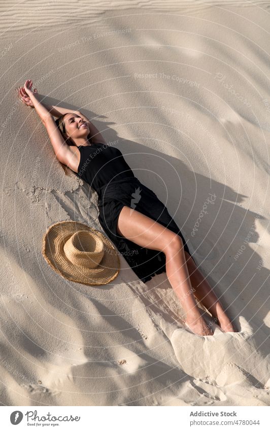 Traveler lying down in desert at sunset tourist stroll hill explore wanderlust nature woman landscape traveler vacation trip island spain corralejo dune tourism