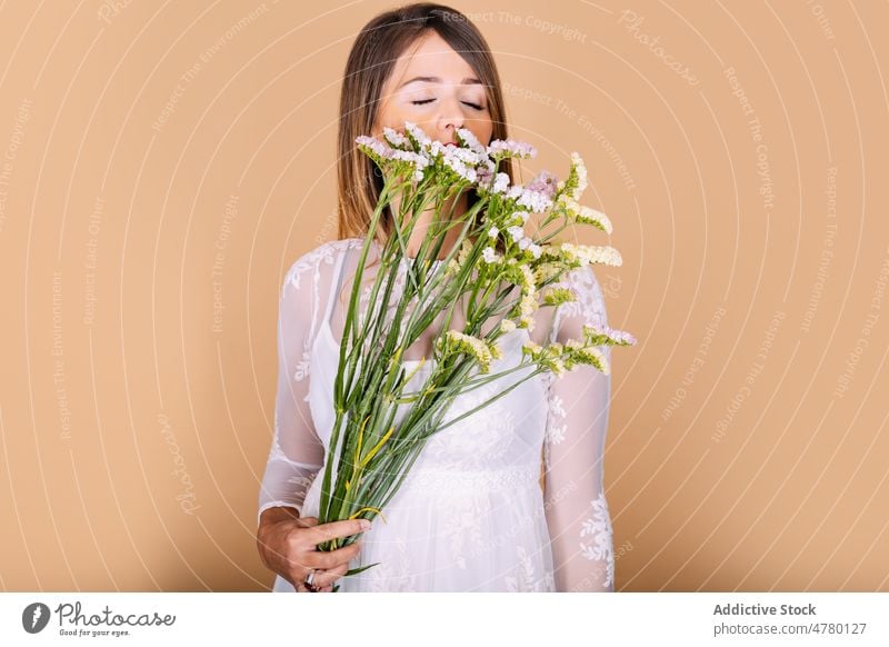 Bride in dress smelling flowers woman bride white dress wedding style occasion bouquet floral event eyes closed elegant plant present fragrant aroma holiday