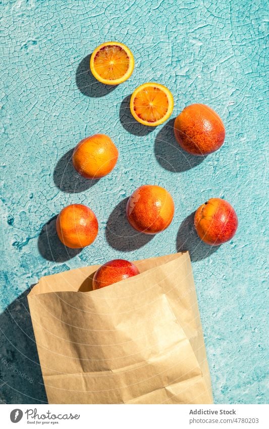 Blood oranges on light table blood orange fruit healthy food natural citrus vitamin organic heap flavor pile fresh room ripe scatter tasty delicious paper bag