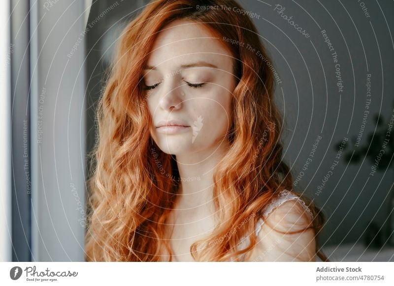 Sad woman with closed eyes melancholy problem upset sad lonely solitude depression desperate dissatisfied room tear cry home tranquil windows curly hair