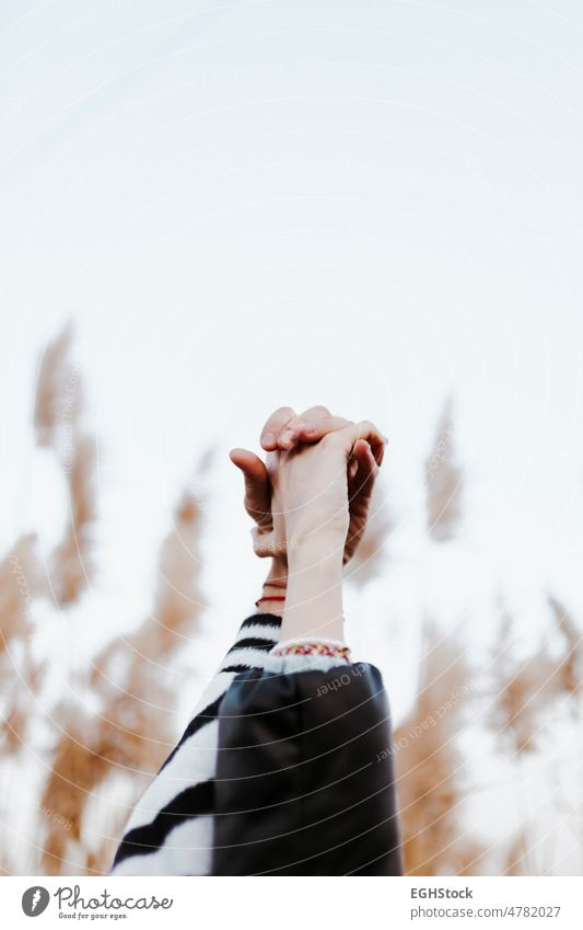 close-up of a couple's linked hands. Woman and man united lovers countryside togetherness connection friendship holding hands community cooperation teamwork