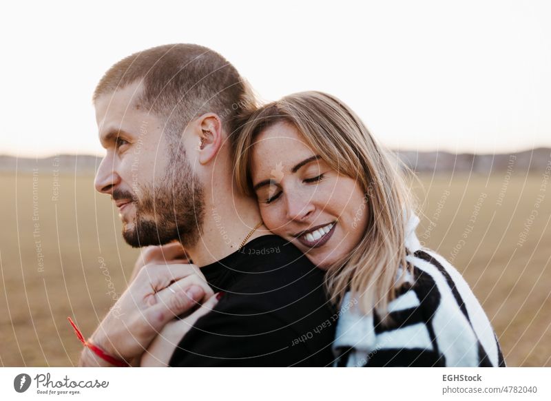 Close up couple hugging in the countryside embraced. Boyfriend and girlfriend in love close up looking at camera two people embracing journey weekend man woman