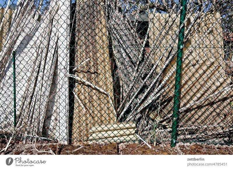 Fence in desolate condition Garden allotment Garden allotments Deserted tranquillity Garden plot Copy Space Depth of field Wire netting Wire netting fence