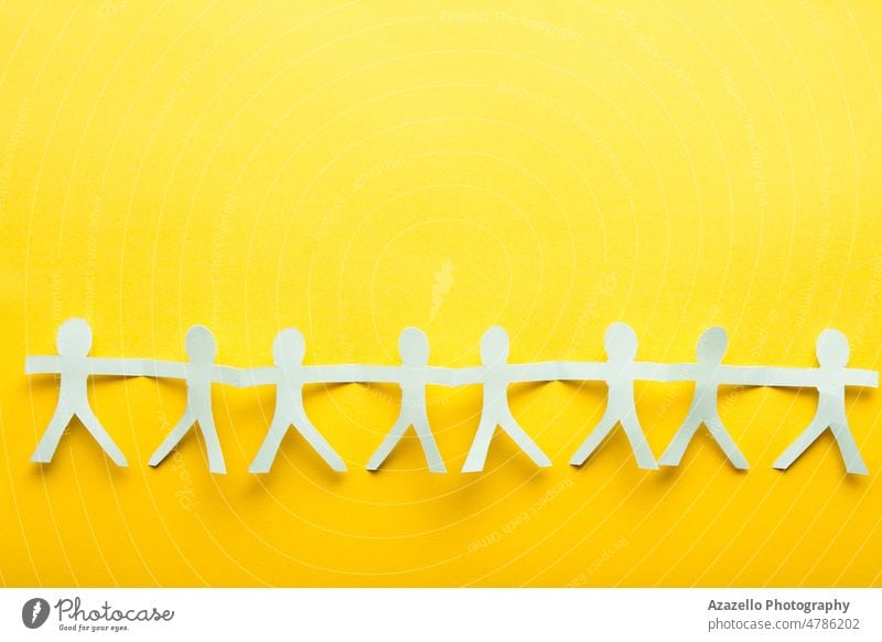 Light blue paper people on yellow background. Friendship flatlay concept. human together friendship conceptual minimalism idea creative simple sunlight ukraine