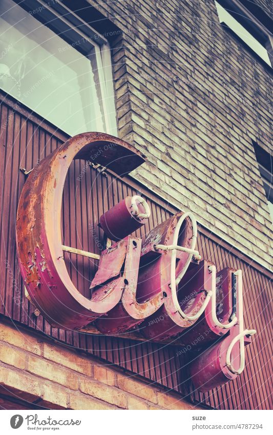 Retrospective with charm Wall (barrier) Wall (building) Facade Characters Town urban Typography Letters (alphabet) English Neon sign Word Colour photo