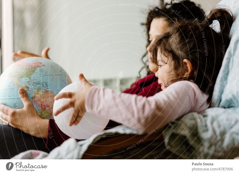 Mother and Daughter playing with earth globe Earth Earth globe Globe Vacation & Travel Planet Sphere Colour photo Blue Geography Continents Globalization