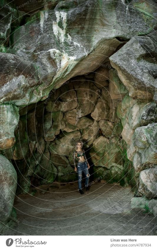 A gorgeous inked girl in a bikini. Lots of tattoos on her skin. And it looks splendid! She’s in some kind of a cave or dungeon. The rocky background is a perfect fit for a rockstar look.