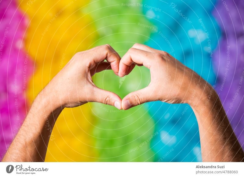 Hands making love heart sign. Rainbow colors background. Gay pride symbol. bisexual colorful community discrimination diversity equality festival flag freedom