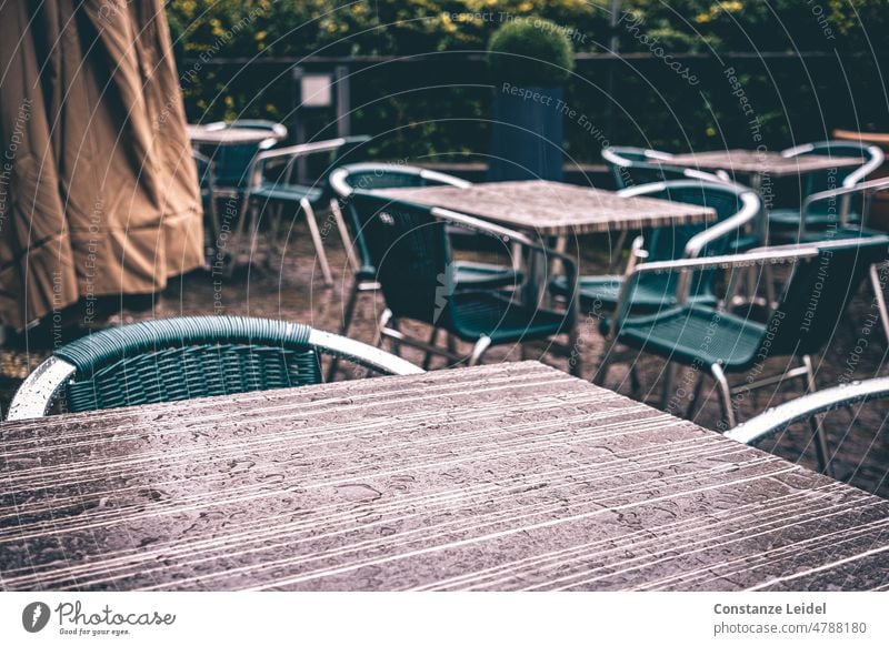 Empty sidewalk cafe with raindrops on the tables Rain rainy day Table Café Ice-cream parlor Wet chairs Gastronomy Seating Closed Furniture Sidewalk café Tourism