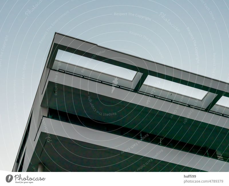 düste diagonal view of the exterior facade of a modern apartment building Modern architecture Exterior Facade Balcony Cloudless sky Twilight somber Architecture