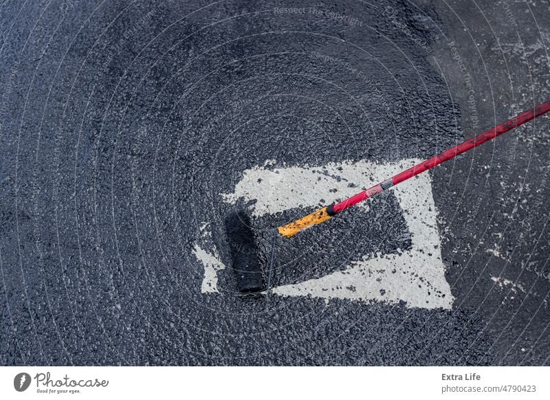 Worker applies one phase of waterproofing with a roller, the first basic layer Activity Apply Asphalt Asphalting Bitumen Bituminous Black Blacktop Brush