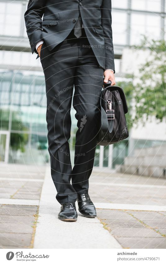 Businessman going to work businessman anonymous professional ceo manager company office elegant elegance briefcase finance financial district city urban street