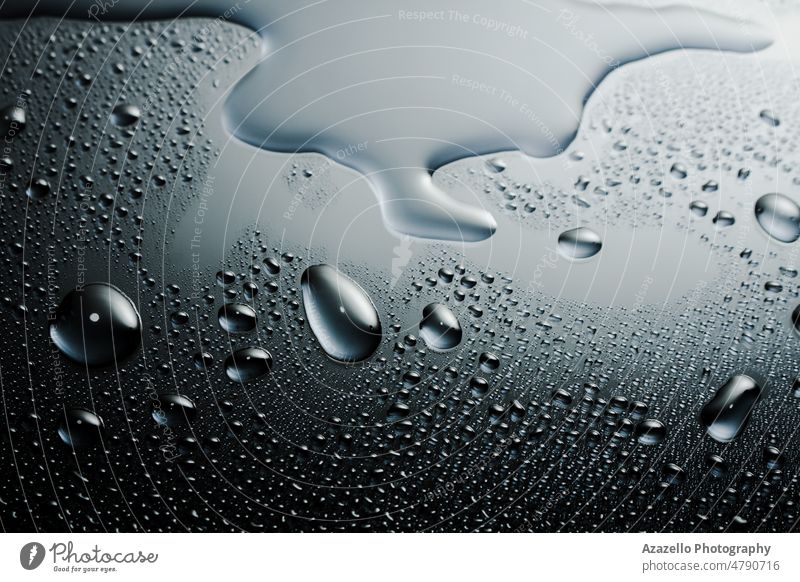 Dark shiny surface with droplets. Close up image of wet shiny background. creative splashing water minimalism rain art blur abstract grey blue black dark