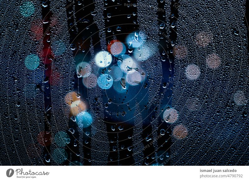 drops on the window and street lights at night colors colorful multicolored bokeh circles raindrops rainy raimy days water glass bright shiny blur blurred