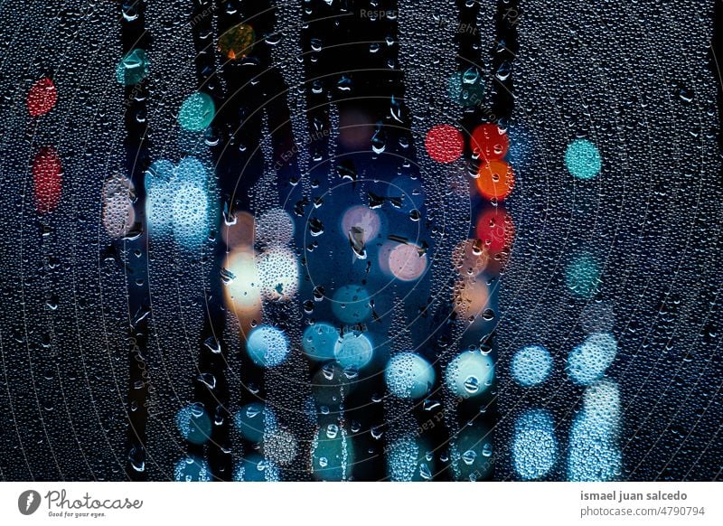 drops on the window in rainy days raindrops water wet abstract background textured lights colorful night street outdoors colors dark bright bokeh blur blurred