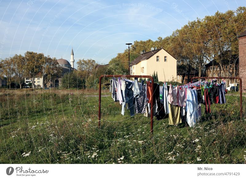 Colorful linen Washing Idyll Place of worship clothesline Backyard Mosque Religion and faith Building Manmade structures Meadow Bushes The Ruhr Landmark Minaret