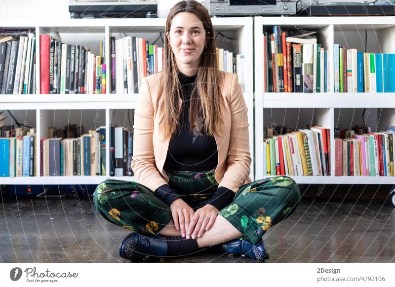 Portrait of a pretty caucasian woman sitting on home ground looking camera indoor 1 lifestyle person beautiful floor meditation yoga girl people attractive