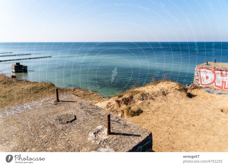 Concrete blocks with sea view Bunker remains NVA GDR Ruins high shore High shore path Historic Baltic beach Baltic coast groynes Horizon Blue sky Cloudless sky