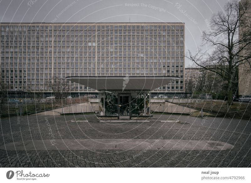 Retro pavilion in front of an anonymous urban skyscraper facade Town High-rise Facade Gloomy Monochrome Window Deserted shabby Building Architecture