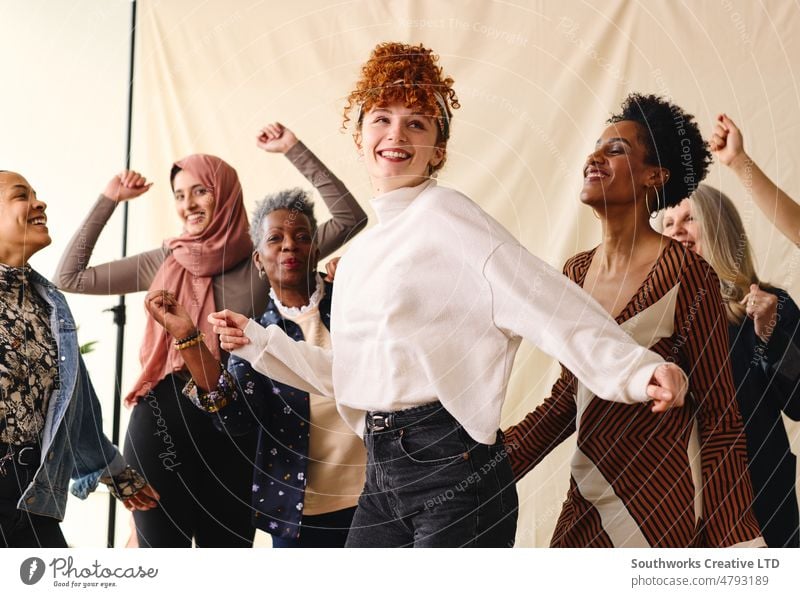 International Women's Day candid portrait of multi ethnic mixed age range women dancing female international womens day iwd empowerment feminist celebration