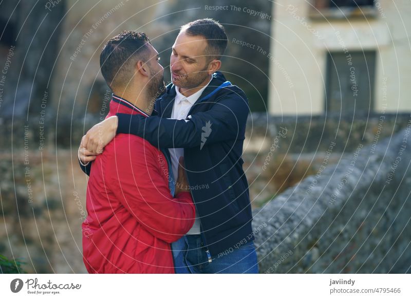 Couple of gay men embracing in city couple homosexual hug love lgbt relationship together happy male lgbtq cheerful embrace tolerance boyfriend equal bonding