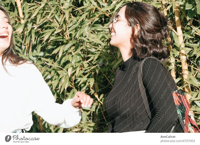 Two young sister embracing each other outdoors the university happy to start a new way on the life, studying together. Muslim Moroccan girls on europe. Happy integration concept.