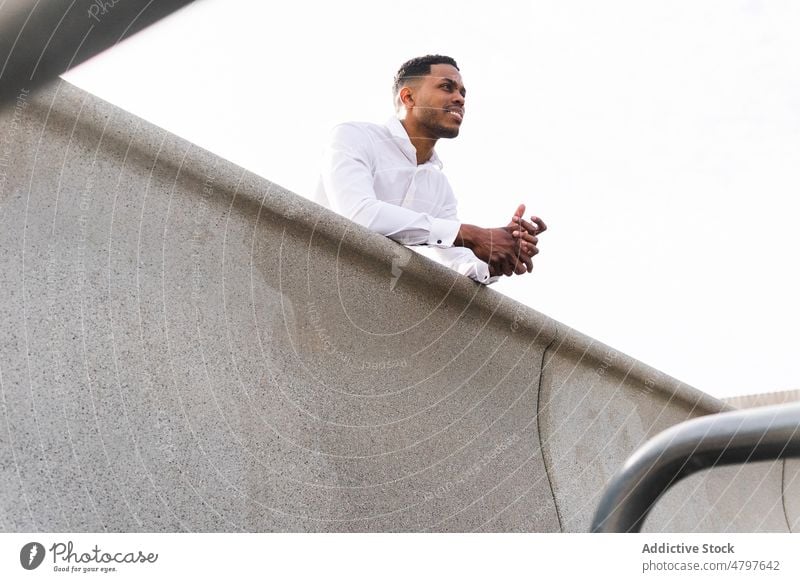 Black businessman standing near modern building entrepreneur african american urban city street black formal style office well dressed respectable manager work