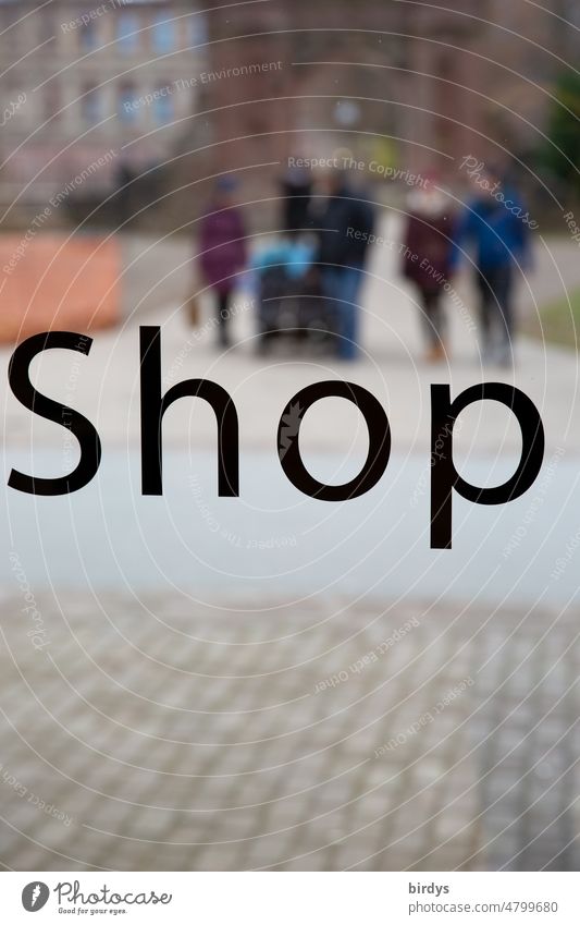 Store, inscription on the window of a store. In the background passers-by in a pedestrian zone Shop Characters Shop window Store premises Retail sector