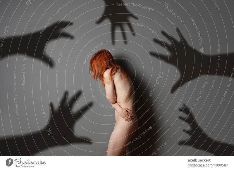 sexual harassment or abuse concept with naked woman shadows of grabbing hands assault violence rape fear person female problem bully depression emotion despair