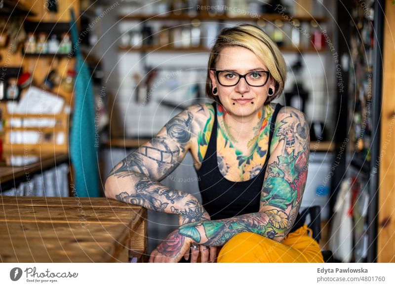 Portrait of young tattooed woman in wheelchair at home Wheelchair Living or residing Self-confidence Woman indoors Home House (Residential Structure) people