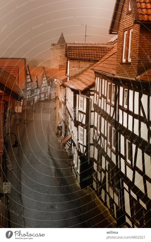 Rain wet half-timbered street Half-timbered houses Alley Historic Tower Wall tower red roofs as field resort Vogelsbergkreis Hesse half-timbered building