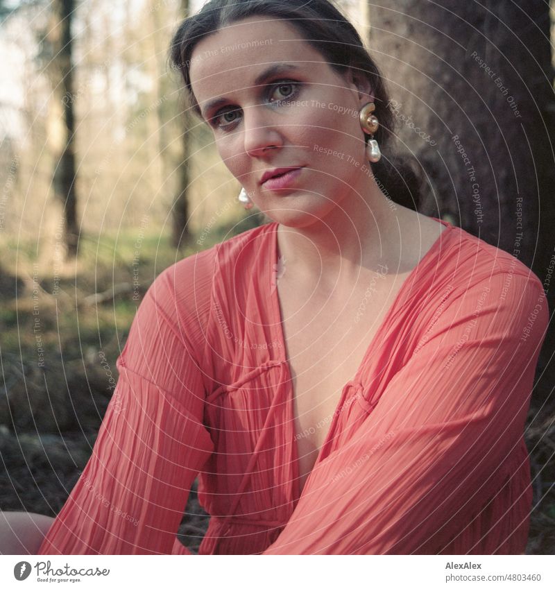 analog medium format portrait of young woman in orange dress sitting in a forest Woman Young woman pretty Feminine feminine Identity Authentic Esthetic Adults