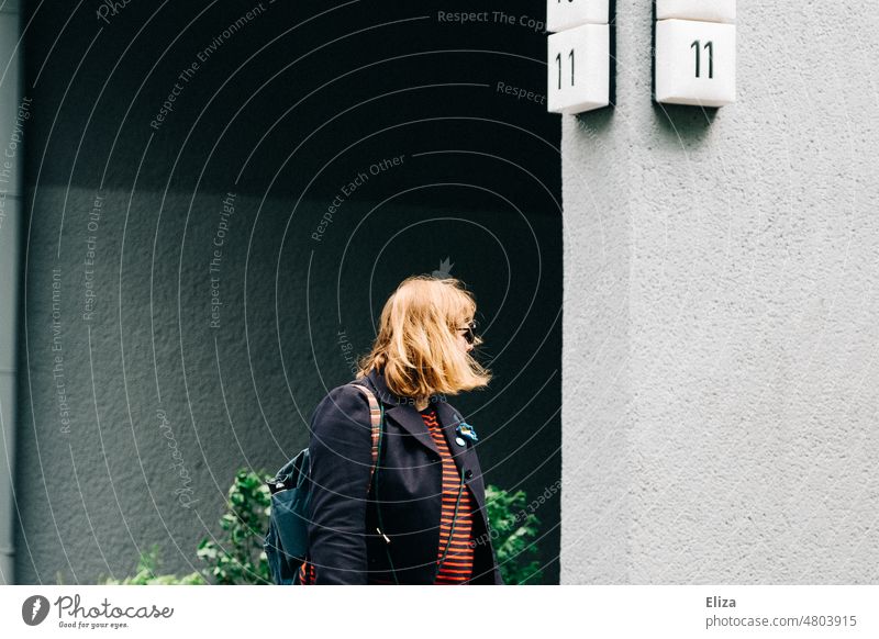 [hansa BER 2022] A woman with medium-length blond hair under house number 11 Woman medium-length hair Blonde Wall (building) Apartment Building blonde hair