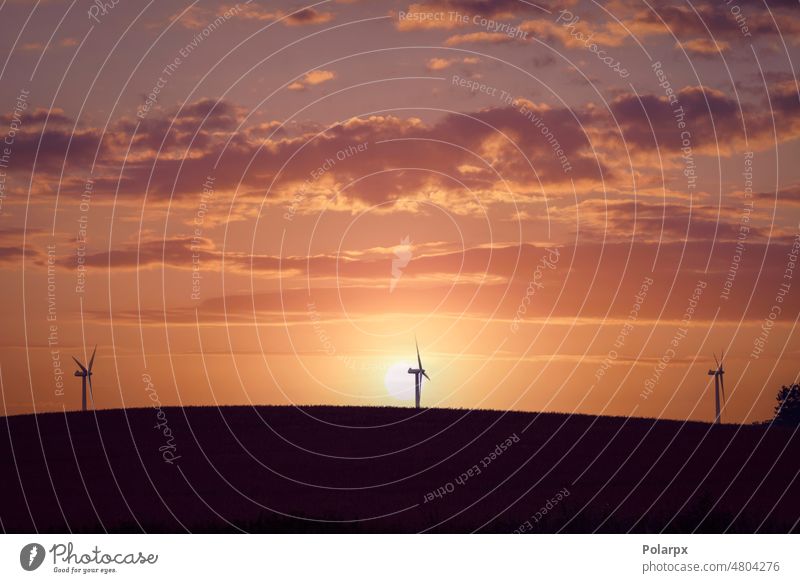 Windmill silhouettes on a hill background rotate supply white generate efficiency station innovation rotation climate outdoor wind turbine wind-turbine