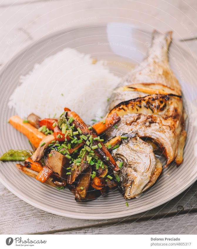 An exquisite dish of baked sea bream with white rice calories cooked cooking cuisine deep fried delicious diet dinner eating fillet fish food fresh fried fish