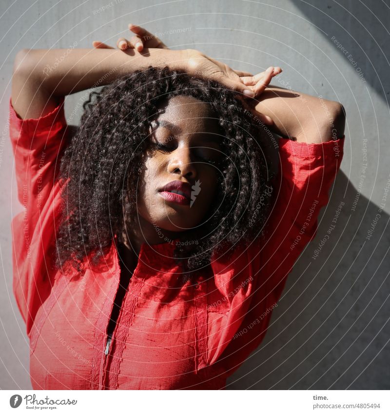 Woman in red dress feminine Dress Curl Dark-haired Wall (building) Wall (barrier) sunny Shadow Sunlight Downward Feminine Lounge stop Interlock Arms raised