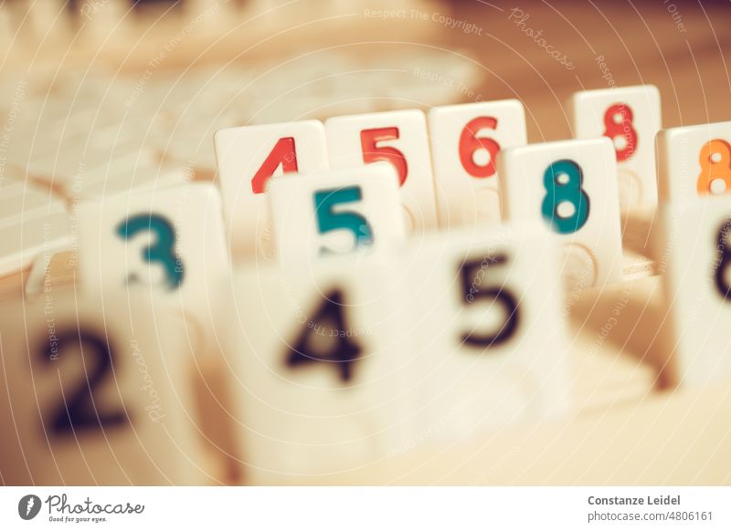 Table game Rummy with set up number tiles rummy Abstract Structures and shapes Numbers Digits and numbers Sign Detail Close-up Characters Red Green Black