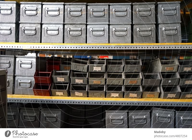 Old steel shelf with boxes and boxes for small parts in an old factory hall in the district of Margaretenhütte in Giessen on the Lahn River in Hesse, Germany